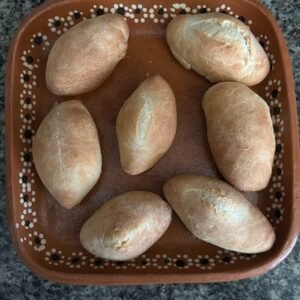 Bolillo bread stuffed with cream cheese and jalapenos
